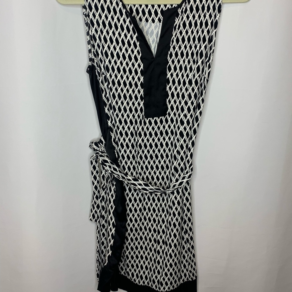 Sleeveless dress. Worn twice. Black and white with tie up belt.